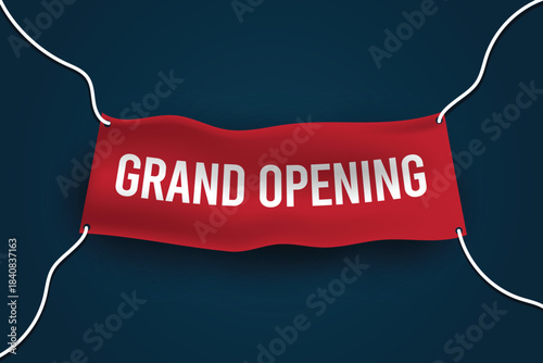 red cloth banner with the words grand opening written on it