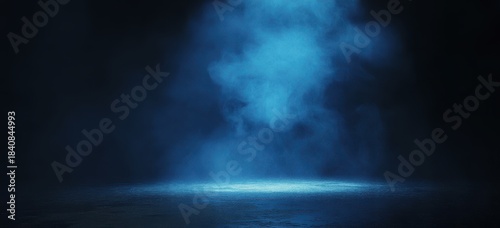 Blue spotlight beam illuminating a textured surface in darkness