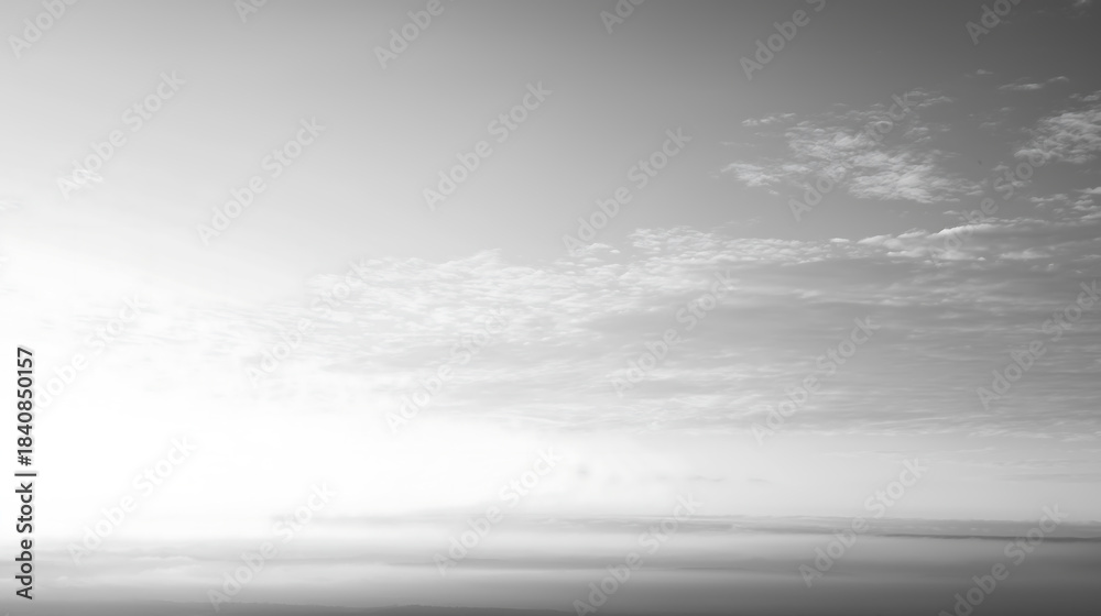Obraz premium Cloud Dancer Serene Black and White Hazy Sky with Scattered Clouds and Distant Horizon, Creating a Minimalist and Atmospheric Landscape. Colour of the Year 2026