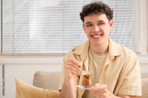 Young man with Turkish tea ...