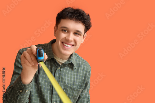 Young man with tape measure...