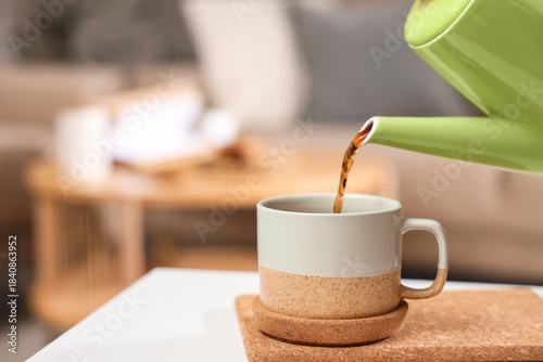 Pouring of coffee into cup ...