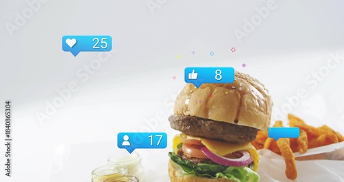 Blue badge popping, sesame burger rising, badges floating, hand placing fries, showing product