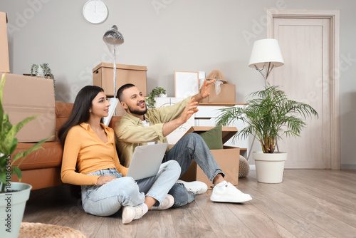 Young couple with laptop in...