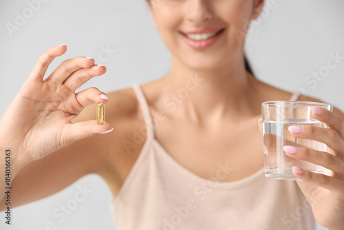 Young woman with vitamin E ...