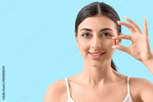 Young woman with vitamin E ...