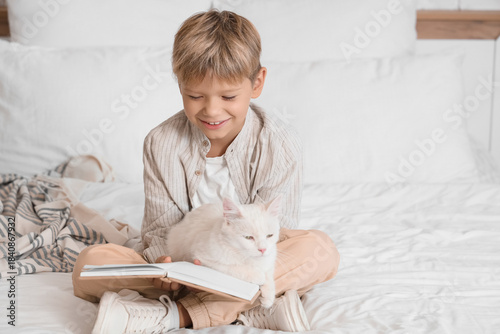 Little boy with cat reading...