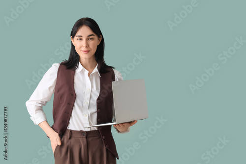 Young secretary with laptop...