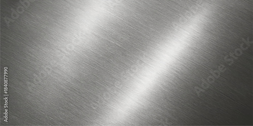 Brushed metal background: a shiny stainless steel texture with a smooth silver metallic pattern and light reflection on the gray aluminium surface