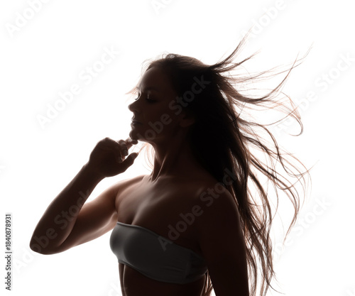 Silhouette of beautiful woman with waving hair on white background
