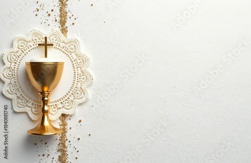Golden chalice with cross on lace. Religious symbol for first communion invitation. Glittering particles around holy sacrament. Copy space for text.