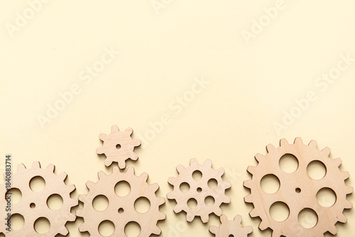 Wooden gears on beige backg...