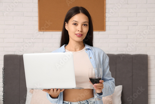 Young Asian woman with glas...