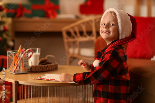 Cute little boy writing let...