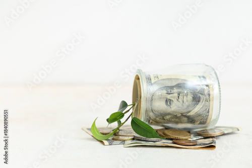Overturned jar with coins, ...