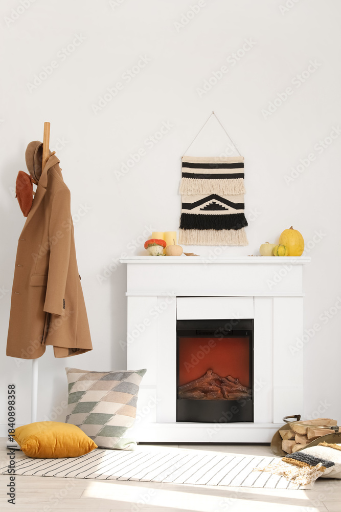 Obraz premium Interior of living room with fireplace, pumpkins and rack