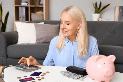 Mature woman counting money at home