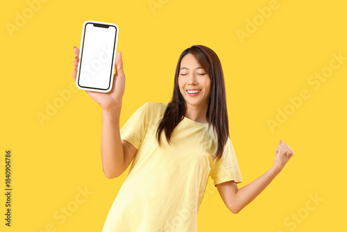 Happy young Asian woman wit...