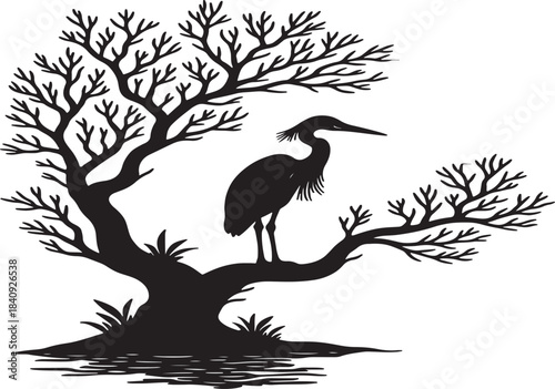 A serene black silhouette of a heron perched within a bare tree s branches