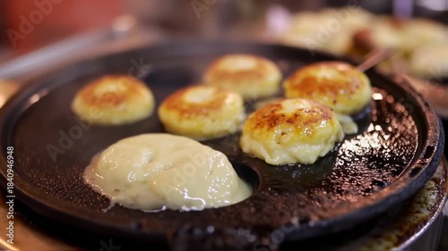 Delicious Potato Patties Frying on a Hot Griddle.
