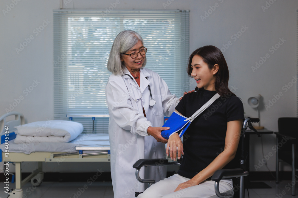 Fototapeta premium Doctor assisting patient with arm injury recovery in hospital