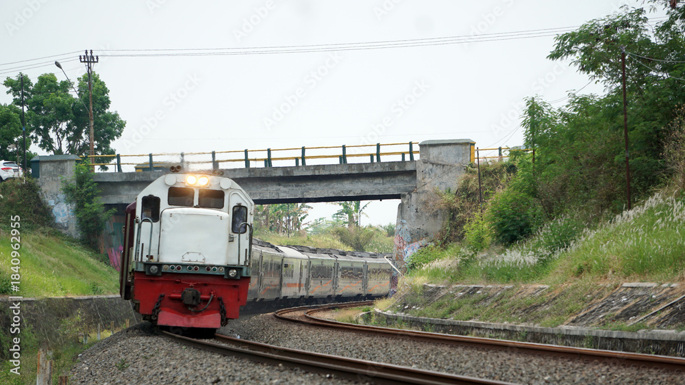 Fototapeta premium A fast-moving train glides smoothly along the railway tracks, showcasing power, motion, and precision in transportation