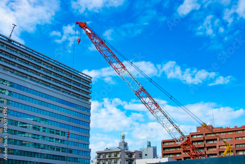 A cityscape of cranes at the under construction in the urban city in Tokyo