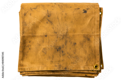 Folded dirty tan canvas tarp cover with metal grommets isolated on a transparent background