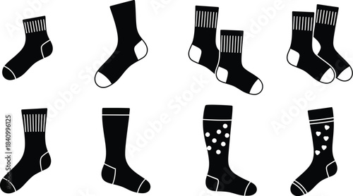 An assortment of black and white patterned socks displayed in a grid arrangement