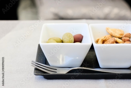 Canvas Print Close-up image of mixed olives and assorted nuts served in small appetiser bowls