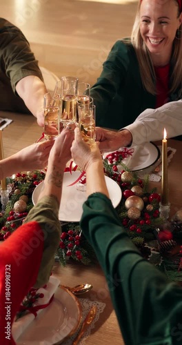 Champagne, cheers and hands of family at christmas dinner in home with celebration, holidays and festive. Sparkling wine, toast and top view of people with alcohol at xmas gathering in dining room.