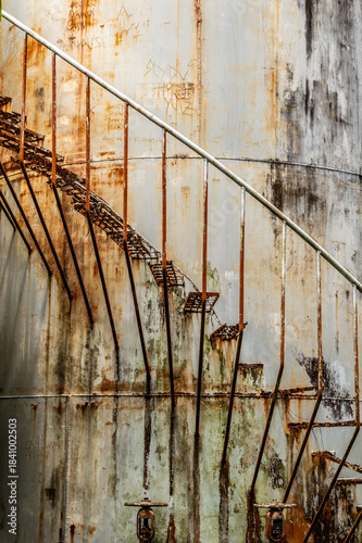 old rusted stairs on a storage tank