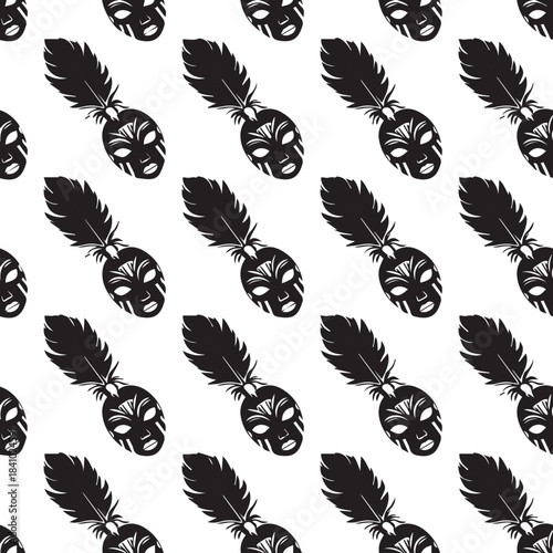 Seamless pattern of black tribal masks with feathers on white background