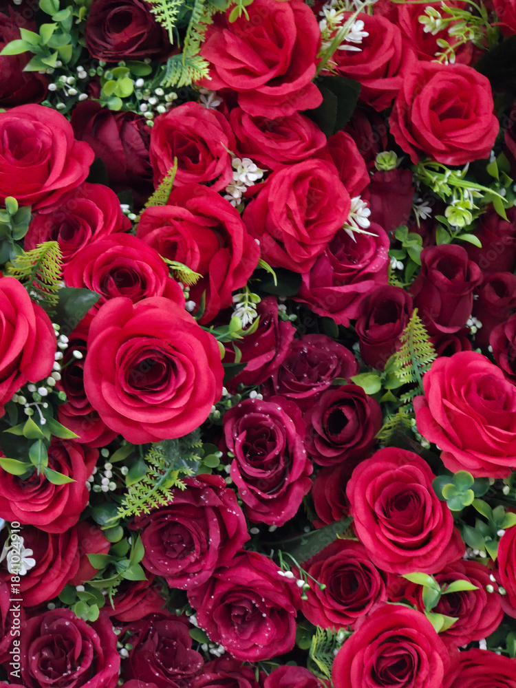 Fototapeta premium Beautiful background of red rose flowers, romantic bouquet symbolizing love and passion. vibrant floral decoration for special celebration or affectionate gift