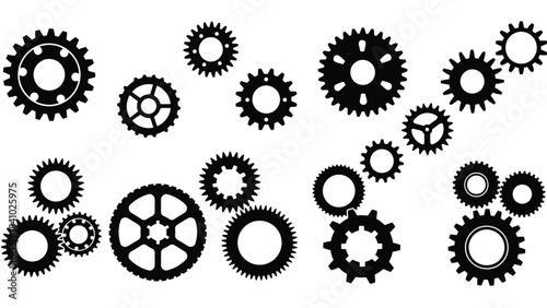 An assortment of black gears and cogs arranged in a scattered mechanical design