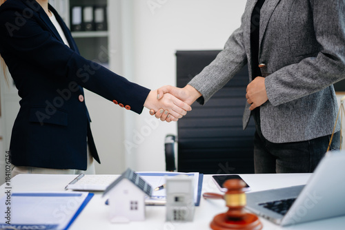 Professional business handshake after real estate contract agreement, showing partnership, trust, and successful deal in office.