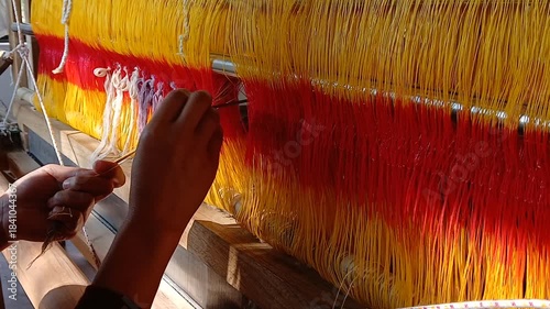 Handloom weaver in India working in her loom.