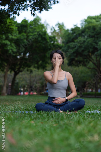 Фотография Woman practice pranayama yoga at green park