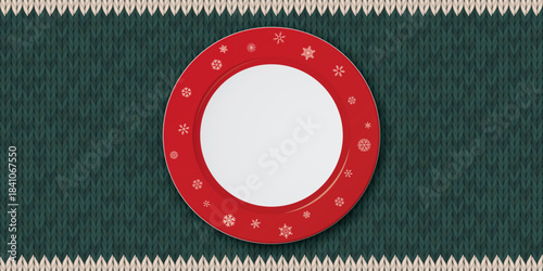 Top view of empty white dish with with red border and snowflake decoration placed on a green placemat background