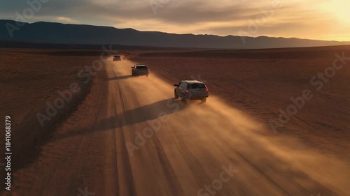 Desert road convoy at sunset aerial footage.