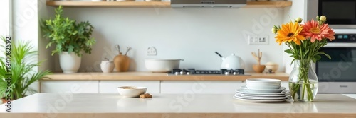 A neatly organized kitchen counter with clean dishes, sparkling appliances, and fresh flowers in a vase Simple, everyday domestic bliss Clean and tidy home environment , flowers, peaceful