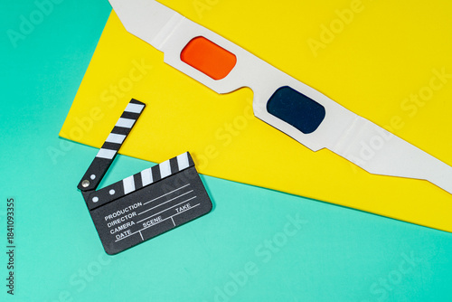 A cine themed still life with 3D glasses and a clapperboard set against vibrant backgrounds. This composition evokes the magic of cinema.