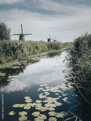 Historische Windmühlen an ruhigem Wasserkanal