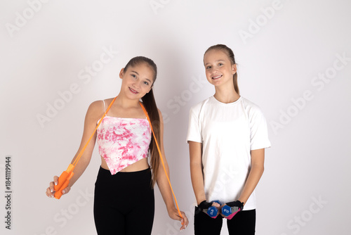 Two teens young adults posing together, showing simple casual style