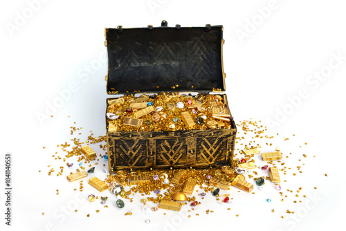 Golden ancient pirate treasure chest that is opened revealing chinese gold ingot bars scattered pile of gold pieces and sparkling colorful cut diamonds isolated on white background.