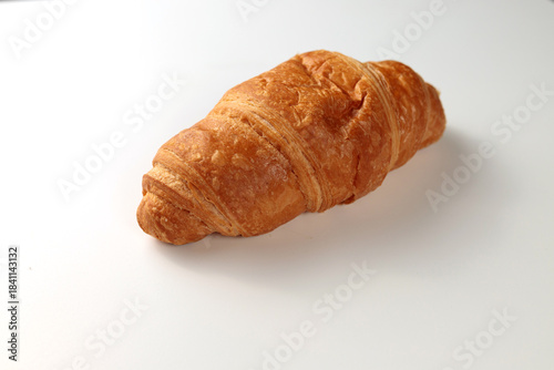 Crispy hot croissant on a white background. Insulation