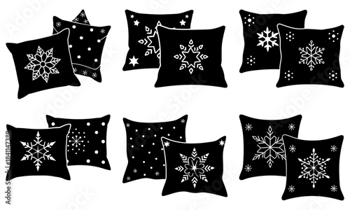 Black square pillows with white snowflake and star patterns on white background snowflakes