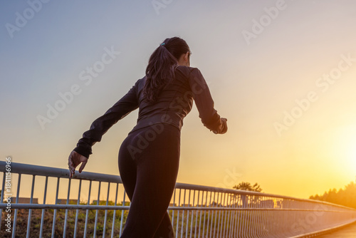 Young Asian girl running and exercising towards the sunshine on the greenway