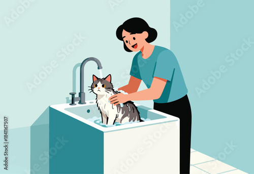 A woman washes a fluffy cat in a sink. The cat sits in water as the woman soaps its fur, smiling