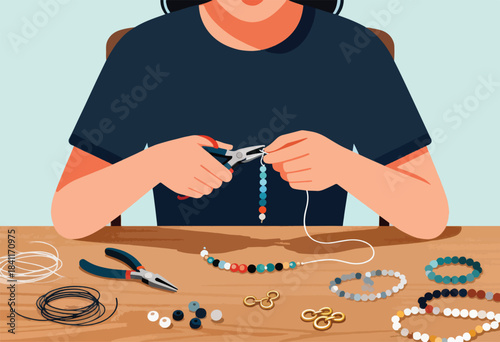 A person crafting beaded jewelry with tools on a wooden surface. Finished bracelets are nearby